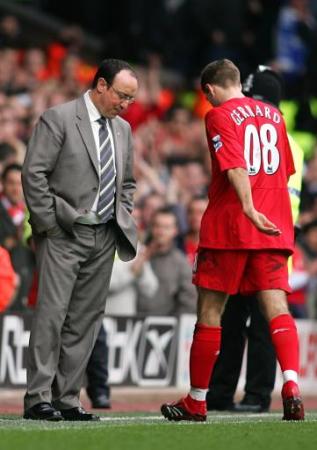 Rafael Benitez can't even look at Steven Gerrard as the Liverpool skipper trudges off after his sending-off in the derby